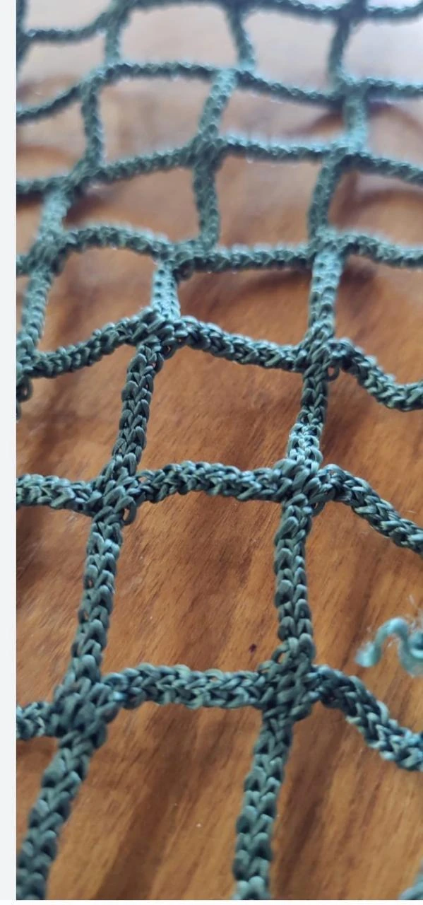Close-up of braided strands and connected mesh openings in a hammock net